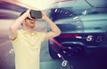 Man in virtual reality headset and car racing game Royalty Free Stock Photo