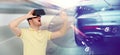 Man in virtual reality headset and car racing game Royalty Free Stock Photo