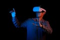 Man is in virtual reality and wearing VR headset. Futuristic concept about technology and connection and metaverse