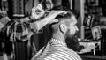 Man visiting hairstylist in barbershop. Barber scissors. Bearded man in barber shop. Work in the barber shop. Man Royalty Free Stock Photo