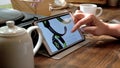 Man visits iWatch website on tablet pc in a cafe