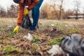 Man volunteer cleaning up the trash in park. Picking up litter outdoors. Ecology and environment concept Royalty Free Stock Photo
