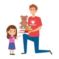 Man volunteer giving a girl books and bear teddy