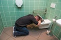 Man vomiting in the toilet Royalty Free Stock Photo