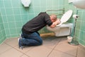 Man vomiting in the toilet Royalty Free Stock Photo