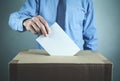 Man voting at the ballot box. Election and democracy concept