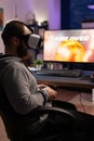 Man with vr glasses playing video games with joystick