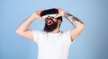 Man in VR glasses screaming. Bearded gamer playing games with VR headset. Hipster with trendy beard having frightening