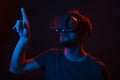 Man in VR glasses touching invisible screen