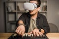Man in vr goggles using MPC pad Royalty Free Stock Photo