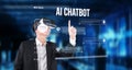 Man in VR headset interacting with AI chatbot interface in a futuristic environment, showcasing generative artificial Royalty Free Stock Photo