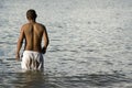 Man wading in lake or sea