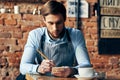 man waiter apron taking order restaurant brick wall