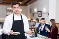 Man waiter dissatisfied with small tip from restaurant visitors