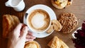 Man Waiter Hand Put Cup of Coffee on Wooden Table with Baked Pastry, Breakfast