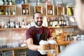 Man or waiter serving customer in coffee shop Royalty Free Stock Photo