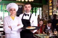 Man waiter and woman cook are standing with order for clients Royalty Free Stock Photo