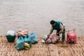 Man Waiting Boat for Moving Commodities in The River at Luang Prabang, Laos