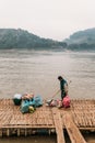 Man Waiting Boat for Moving Commodities in The River at Luang Prabang, Laos