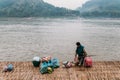 Man Waiting Boat for Moving Commodities in The River at Luang Prabang, Laos