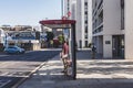 A man waiting for a bus on Agar Grove bus stop, London