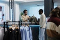 Man waiting for cashier scanning apparel Royalty Free Stock Photo