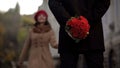 Man waiting for girlfriend, holding flowers, first date, beginning of relations