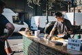 Man waiting for his food at a street food stand in Borough Market, London, UK.