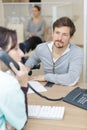 Man waiting while medical receptionist talks on telephone Royalty Free Stock Photo