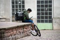 Man waiting in the street with an uber eats backpack and bicycle