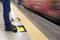 Man waiting for the subway at train station with blurry moving train in background about city transport and travel tourist concept Royalty Free Stock Photo