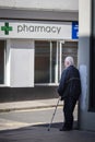 Man waiting to go into pharmacy