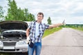Man waiting to help and showing thumbs up near car