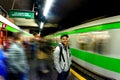 A man waits for the arrival of a train at a subway station in Milan Royalty Free Stock Photo