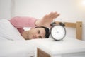 Man wake up doing turn off alarm clock in the morning. Royalty Free Stock Photo