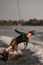 man wakeboarder trying to balance on board while riding on wave Royalty Free Stock Photo