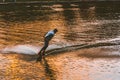 Man wakeboarding on river lake at sunset. Wakeboarder making tricks Royalty Free Stock Photo