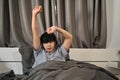 Man waking up in bed and stretching his arms. Royalty Free Stock Photo