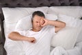 Man waking up after sleeping on comfortable pillow