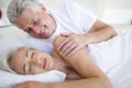 Man waking woman lying in bed sleeping Royalty Free Stock Photo