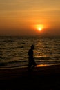 Man walk on the beach on sunset time Royalty Free Stock Photo