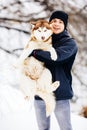 Man walk with his friend red siberian husky dog in snowy park. Toned Royalty Free Stock Photo