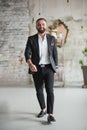 Man walk inside home in black suit,