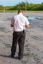 A man with a walkie-talkie at the airport, back view. Island of