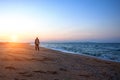 Man walking along the beach during a beautiful sunset relaxation time Royalty Free Stock Photo