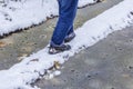 man walking along a narrow path perilous winter at wet weather Royalty Free Stock Photo