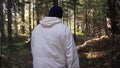 Man walking along path through forest. Footage. Rear view of man all alone. Concept of active recreation in nature Royalty Free Stock Photo