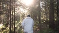 Man walking along path through forest. Footage. Rear view of man all alone. Concept of active recreation in nature Royalty Free Stock Photo