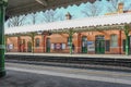 Man walking along the platform of a suburban underground station Royalty Free Stock Photo