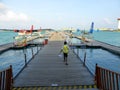 Man walking along pontoon to seaplanes